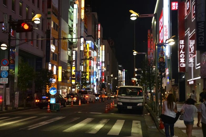 a busy asian city with the light on