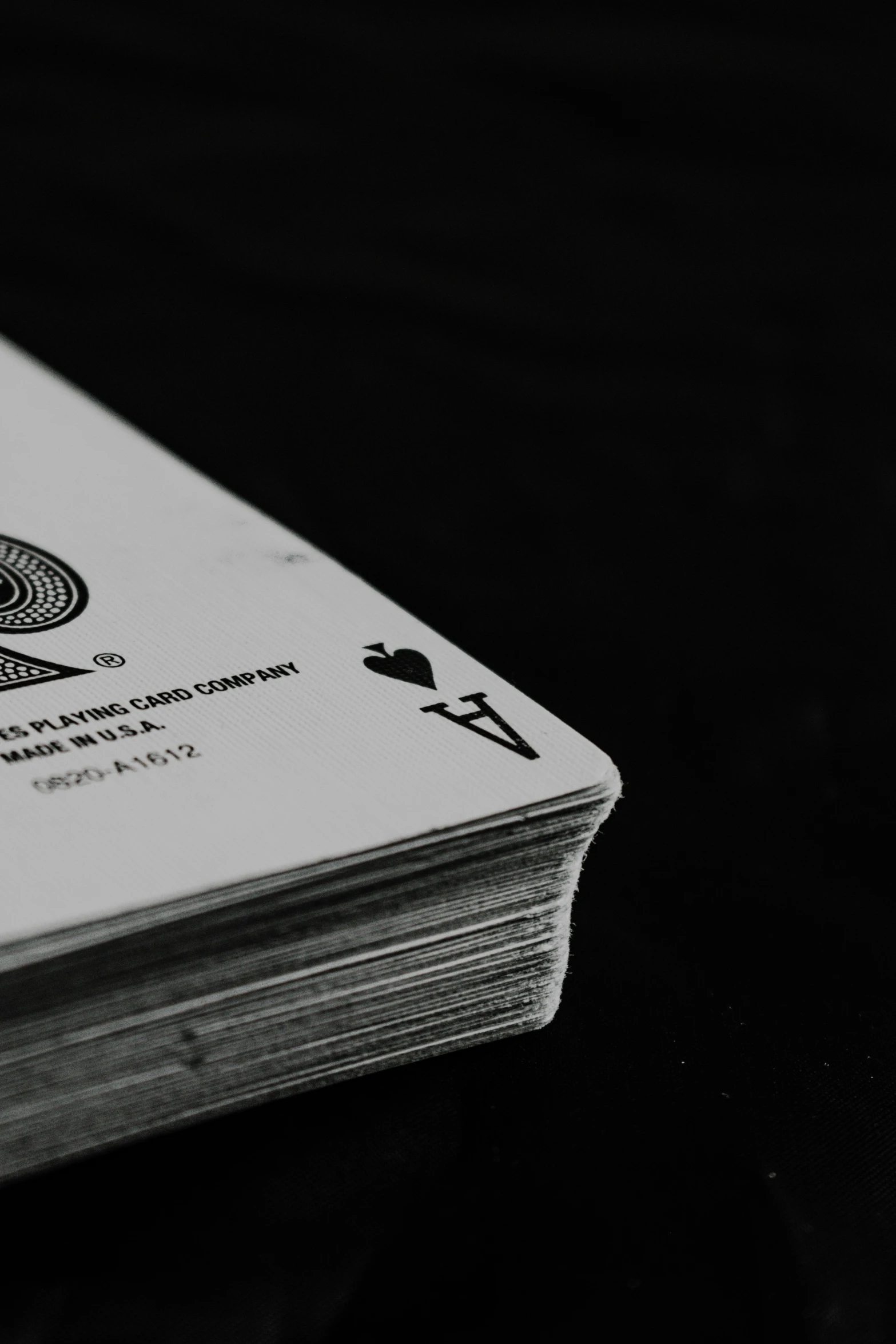 an unopened playing card on a black table