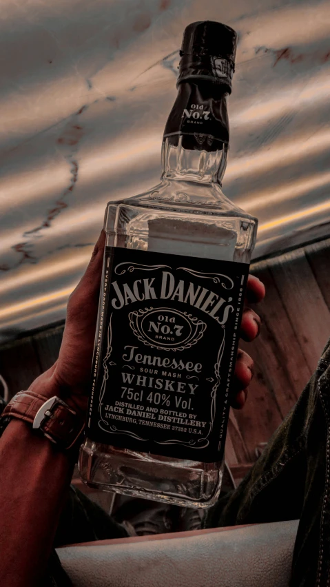 someone holding a bottle of jack daniels