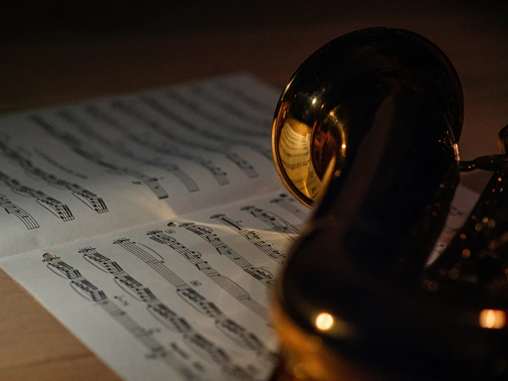 a saxophone laying on top of sheet music