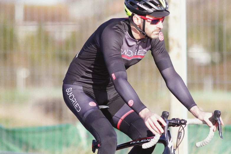 a man riding a bike on top of a field