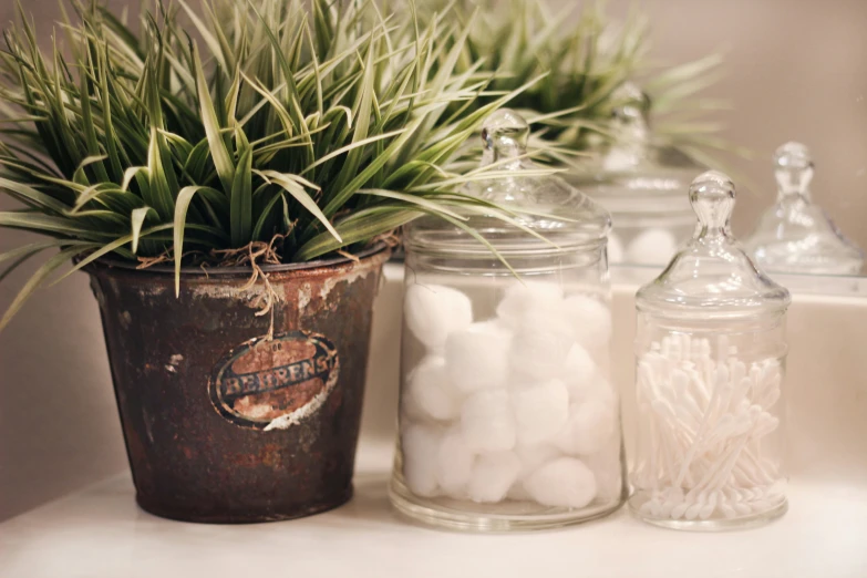 some jars and one with small white ball inside it