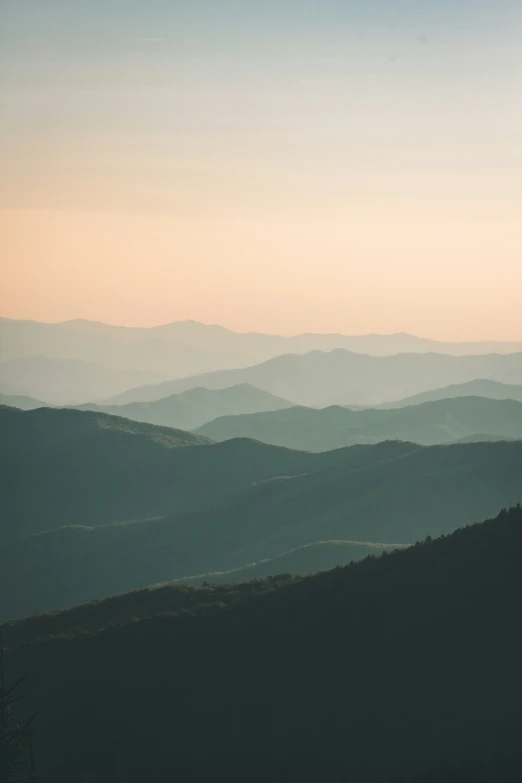 the mountains are covered in fog and light