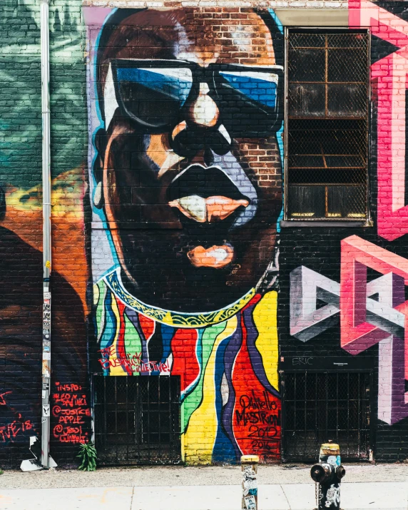 a very large painting of a black man on the side of a building