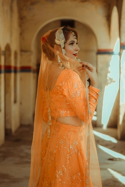 an old image of a lady dressed in an orange outfit