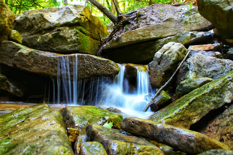 there is a small stream that is running between rocks