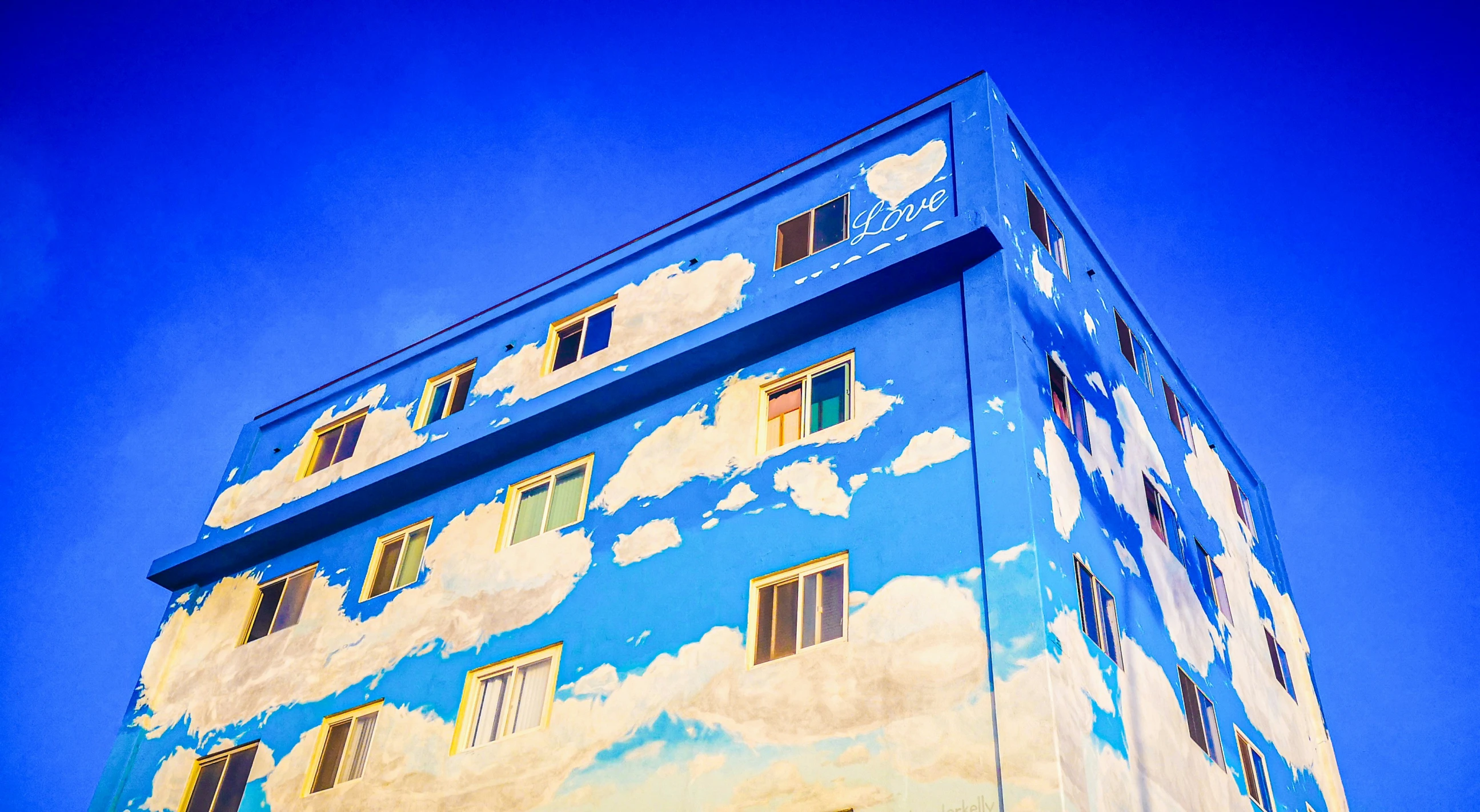 a building that has clouds painted on it