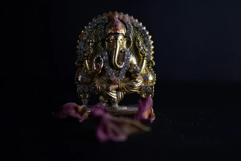 a statue of lord ganesh is surrounded by flowers