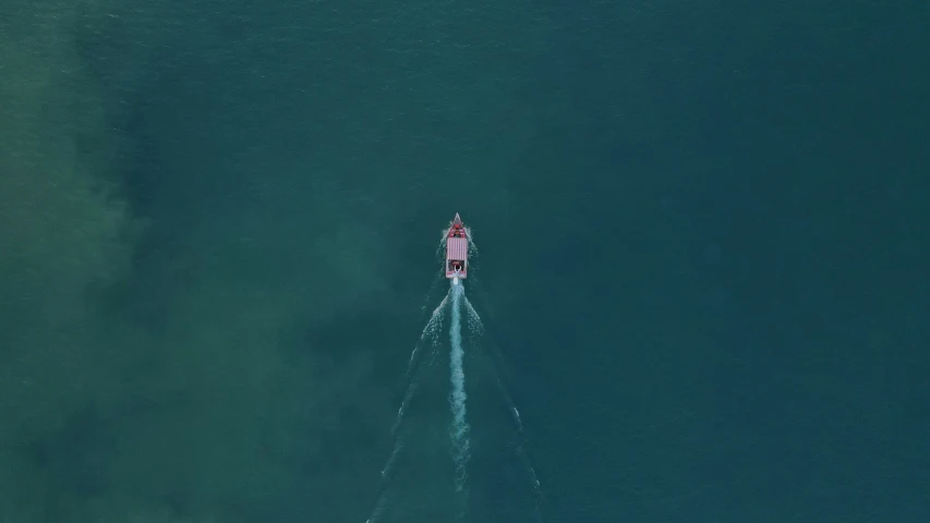 a boat in the middle of blue water