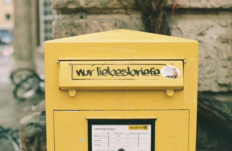 an interesting postbox has a small sign stating war times