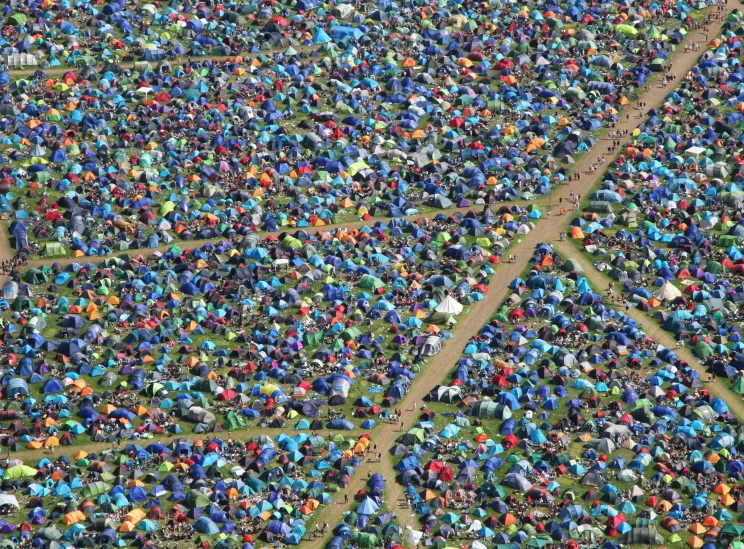 aerial view of a large group of people gathered together in the park