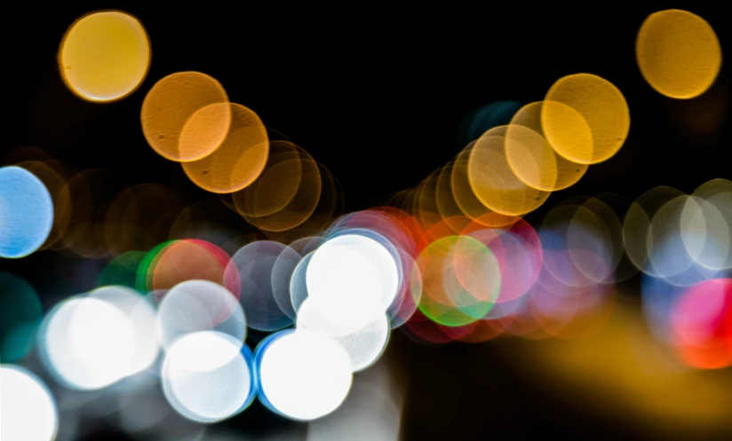 a blurry po shows the street and cars lights