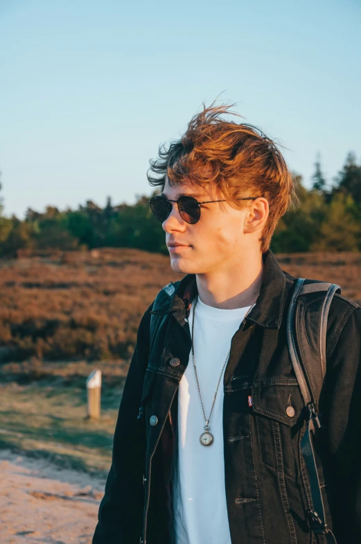 young man in sunglasses looking ahead at the camera