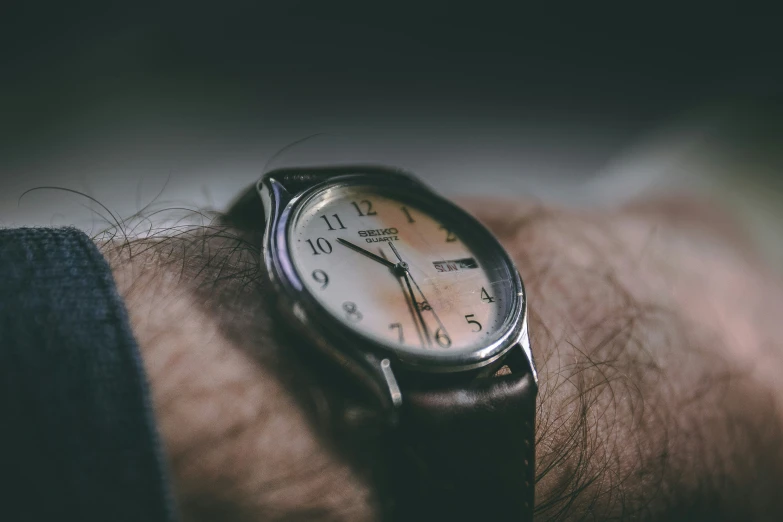 a close up of a wrist watch on someone