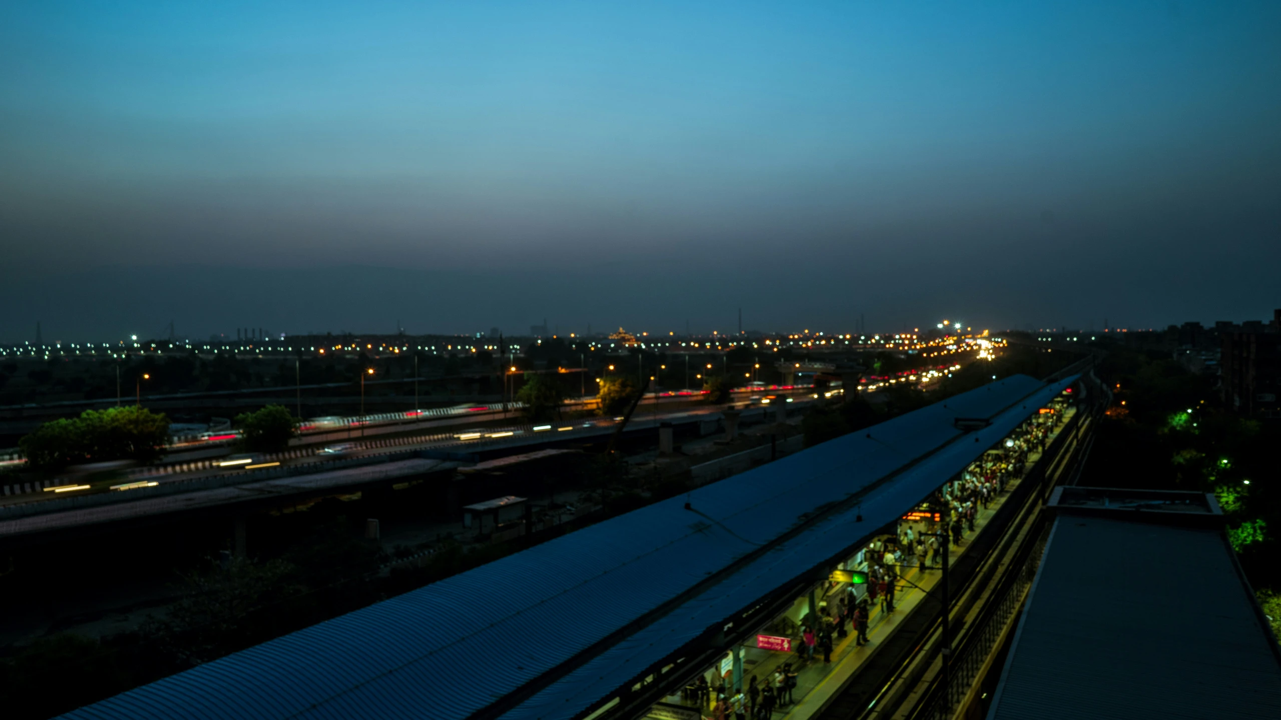 people waiting at the train station in the evening