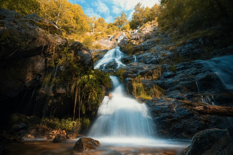 the waterfall on the side of the road is very long