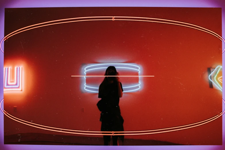 a woman standing in front of neon colored background