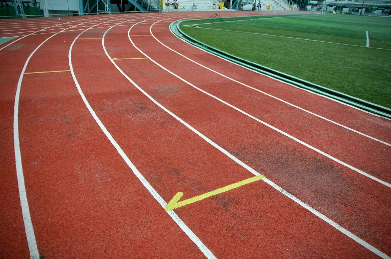 a large track in a stadium with yellow lines