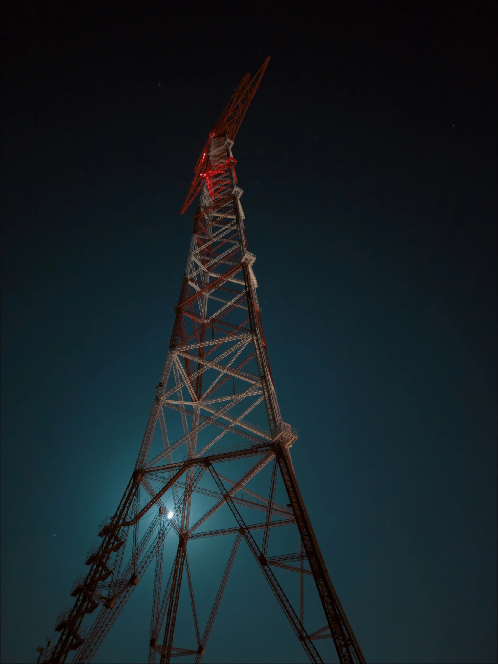 a light shines brightly on a tower at night