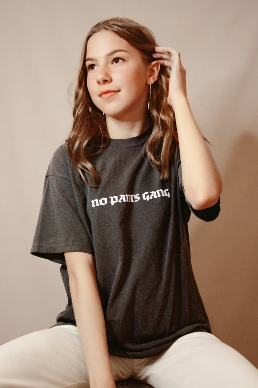 a  wearing a black t - shirt that says no pants cares