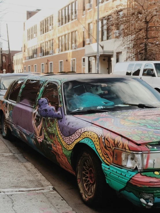 a parked station wagon covered in some colorful paint