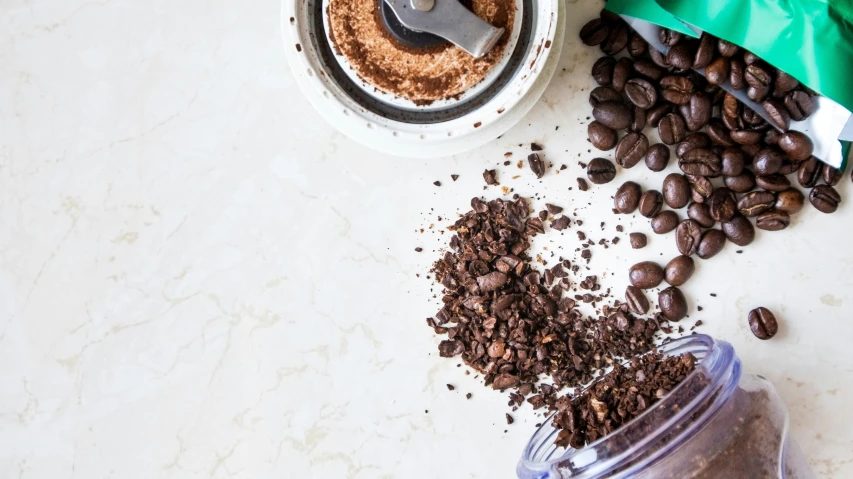 a jar with coffee and chocolate chips in it next to a can