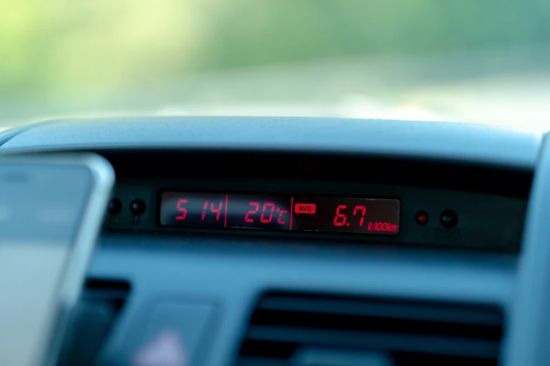 an analog clock sits on top of the radio