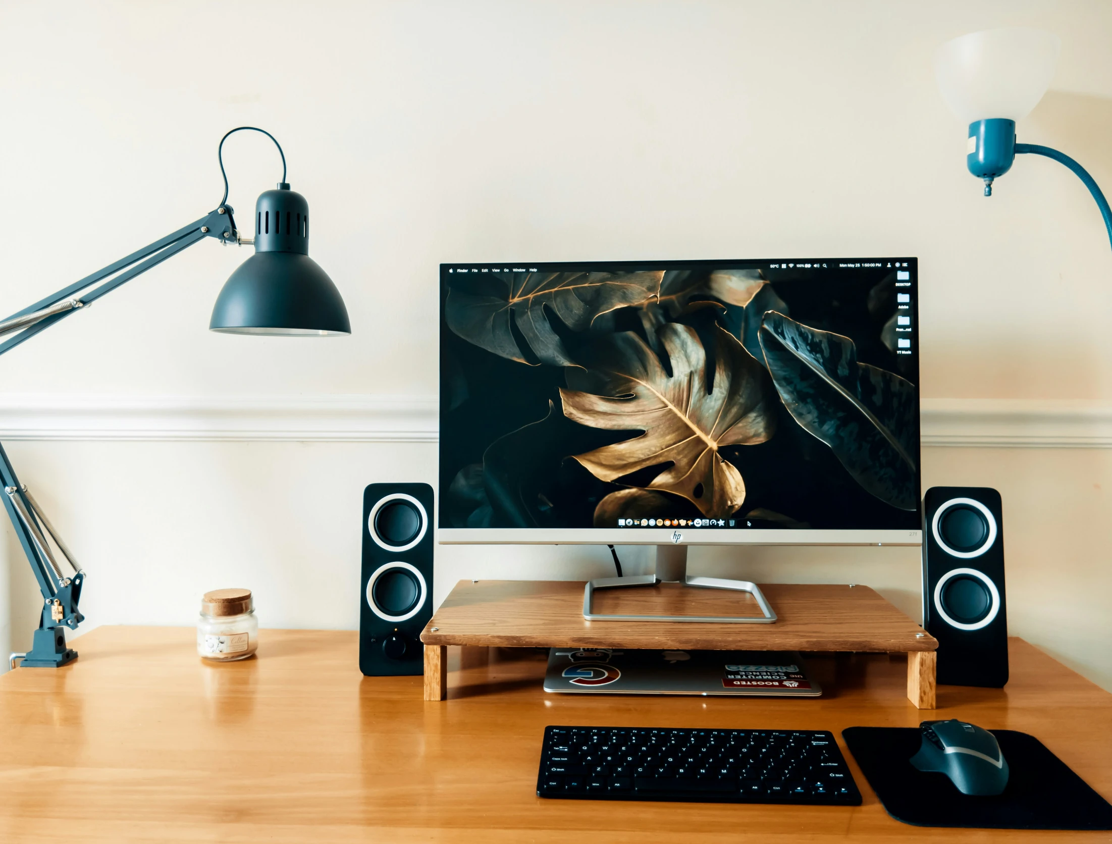 an apple monitor on a desk next to a mouse