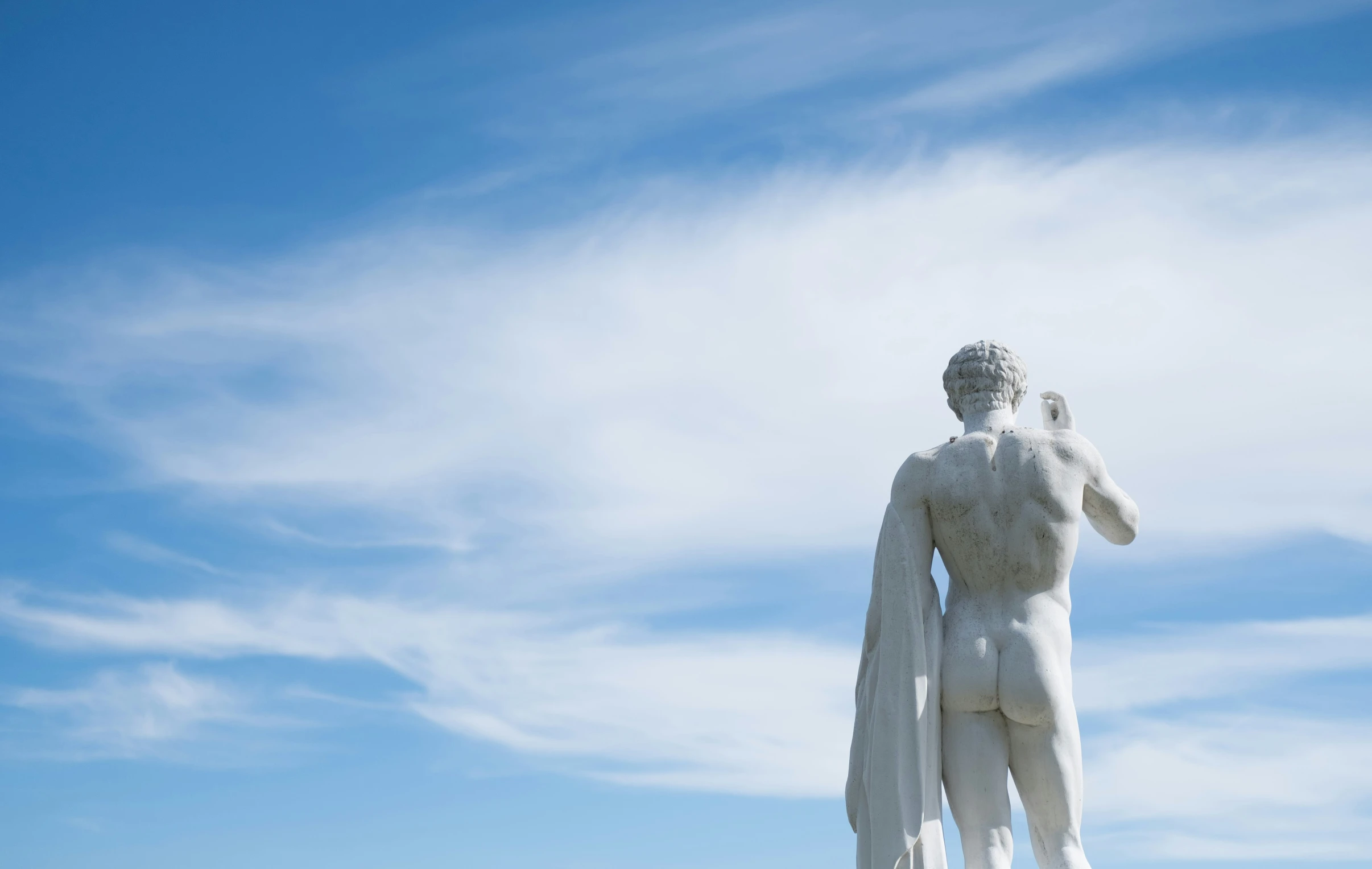 a very large statue holding a bird in his hand