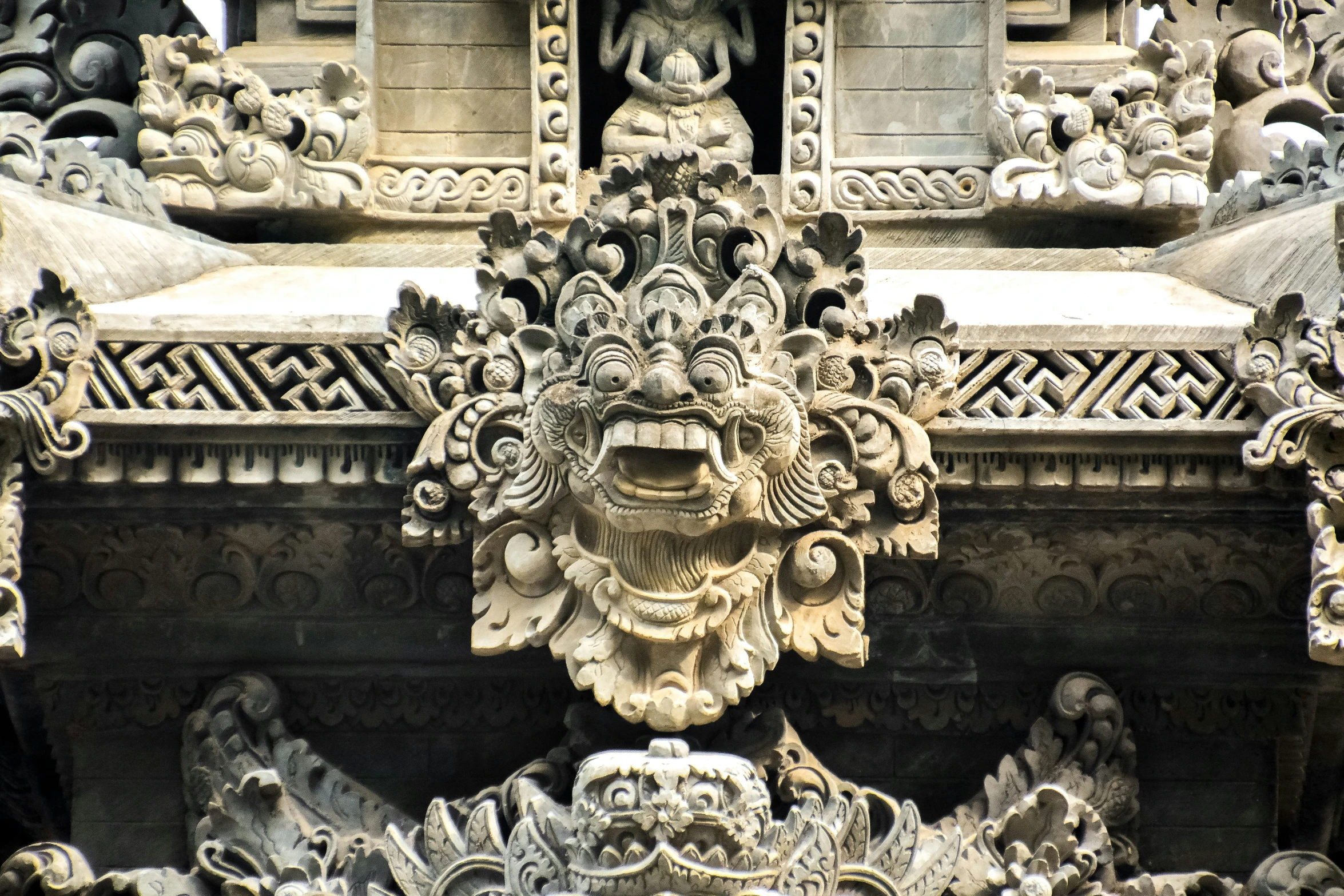 the intricate carving on a temple building has a lion face