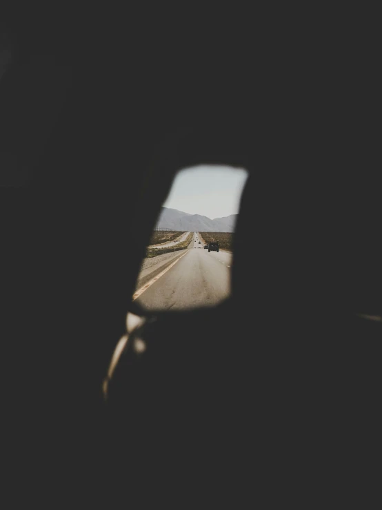 an open window with a long road in the background