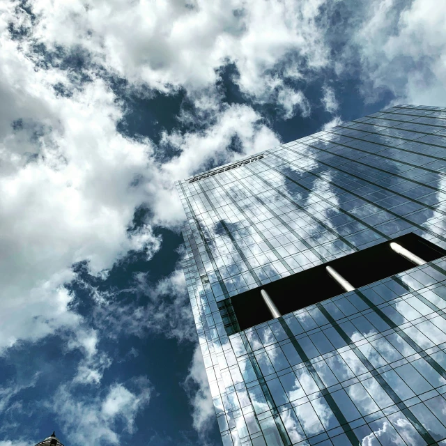 the view from below of skyscrs, on a cloudy day