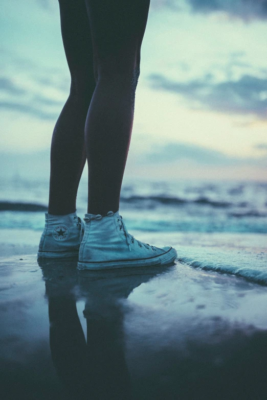 person walking on the beach holding hands