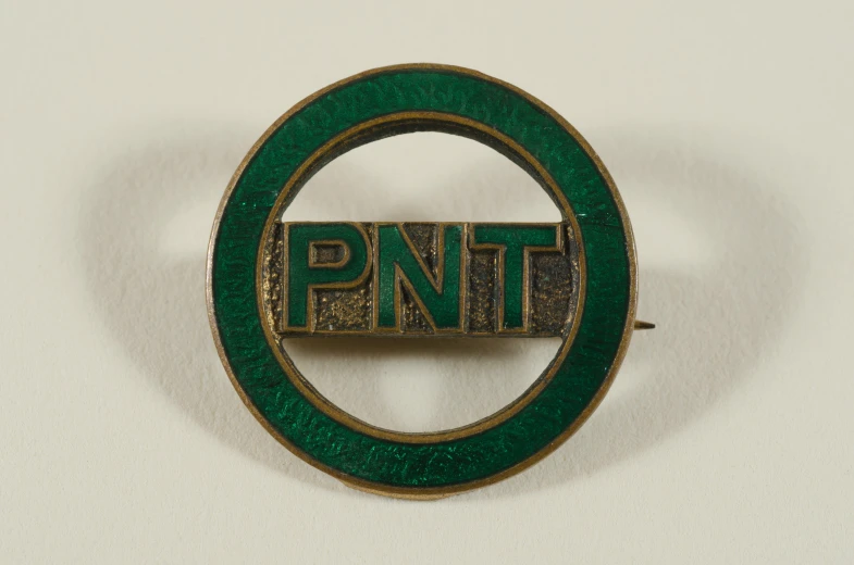 a pin that says pnt on a circle