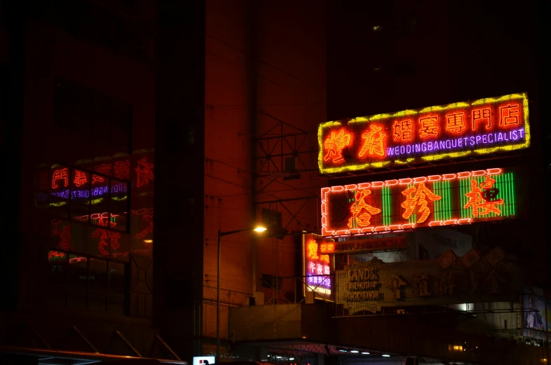 the lighted signs in the city at night are asian