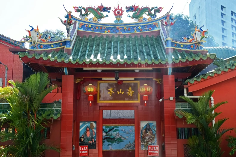 a building has a oriental - like roof and red front door