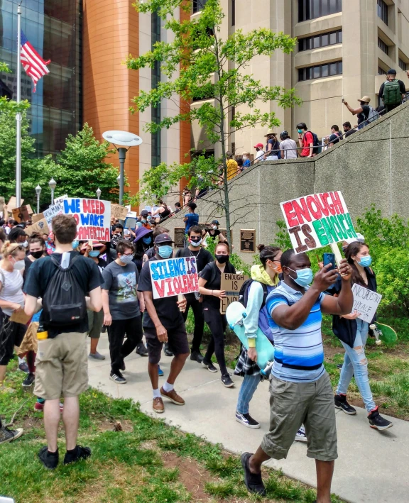 a group of people on a sidewalk with signs