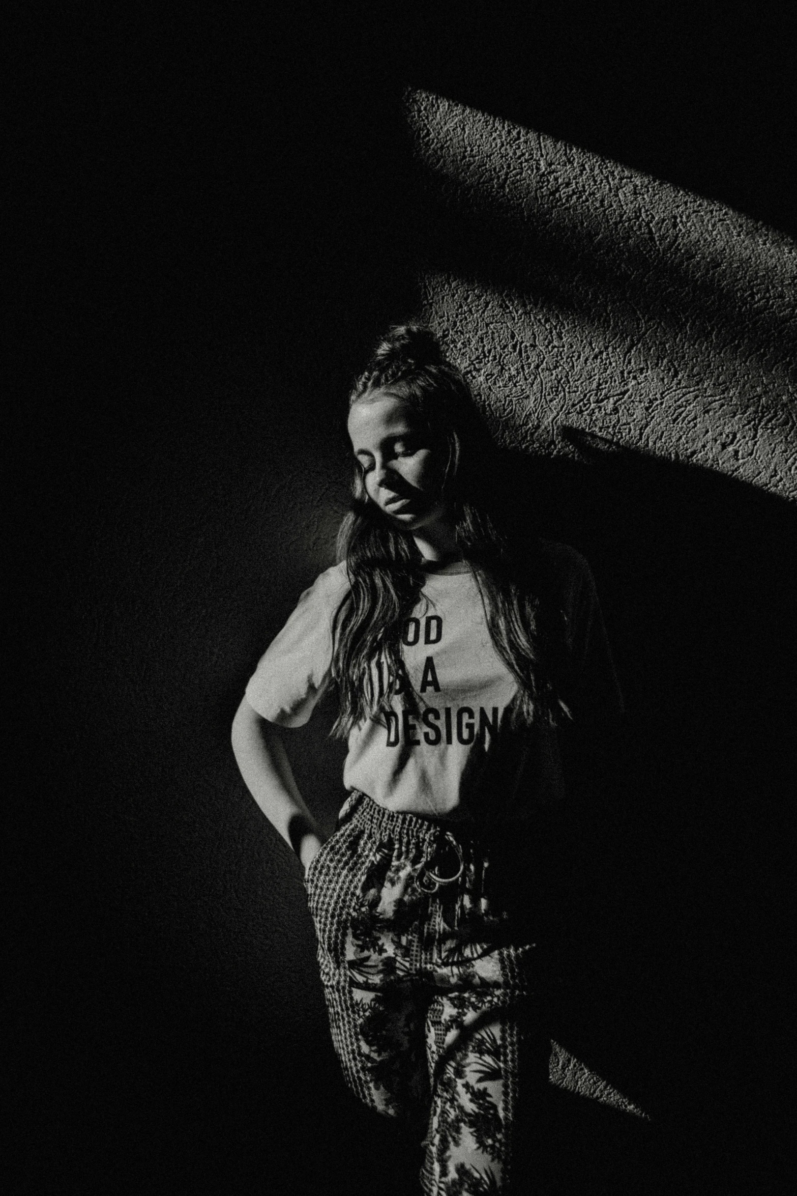 a black and white po of a girl standing in the dark