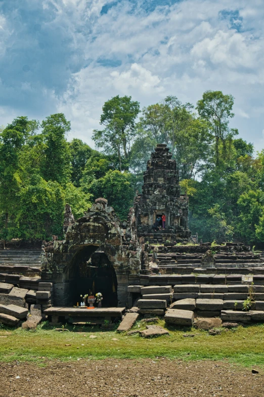 an elaborate stone entrance with steps leading into the distance