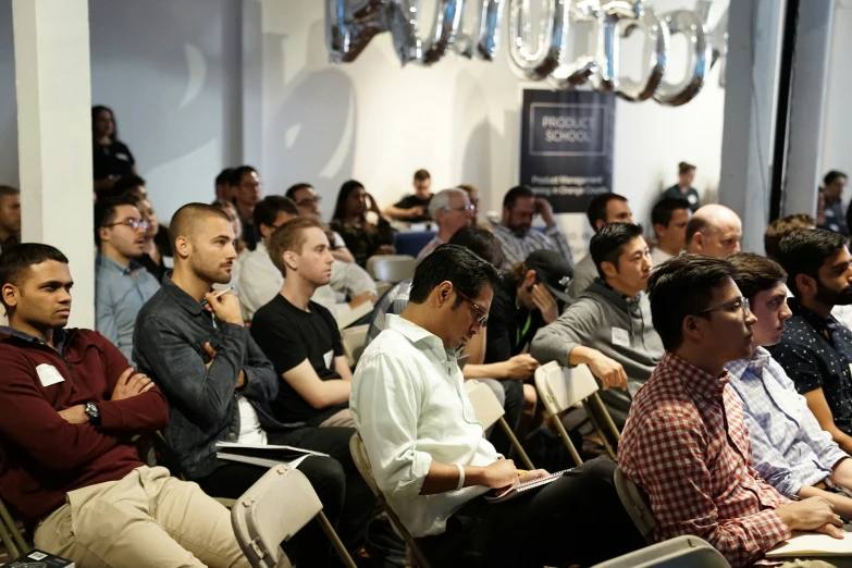 a large group of people are attending a meeting