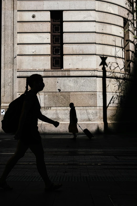 two people walking in the street as one passes