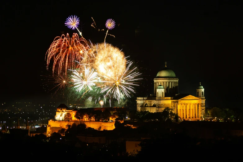 a large fireworks display over the top of buildings