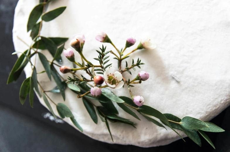 a white napkin with pink flowers and green leaves on it