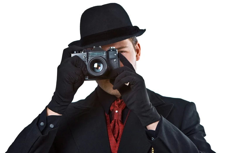 the man is wearing a black hat and holding a camera