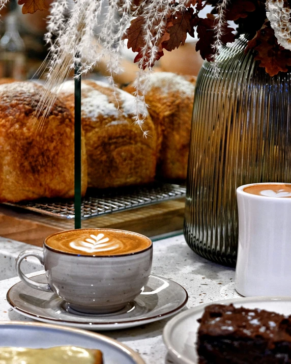 this table has pastries, plates and cups on it