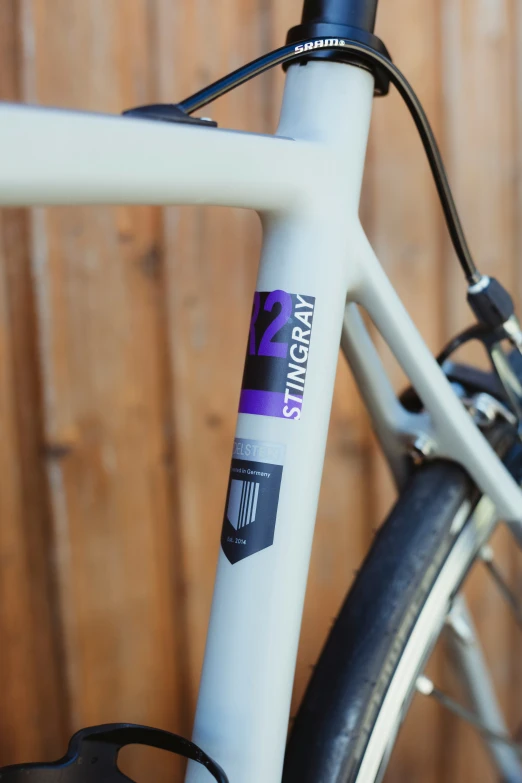 the ke of a bicycle with purple and blue stickers on it