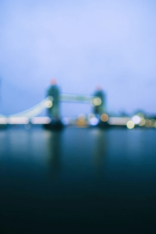 a blurry image of a bridge lit up