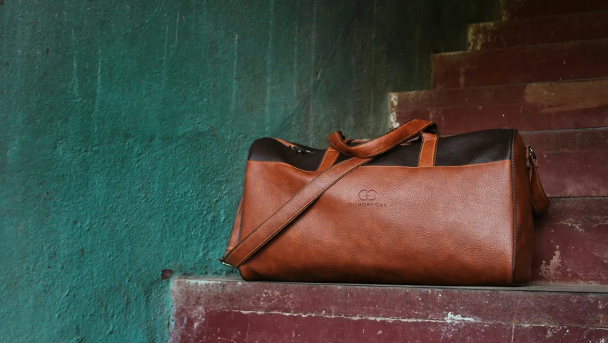 a brown bag resting against a wall on the street