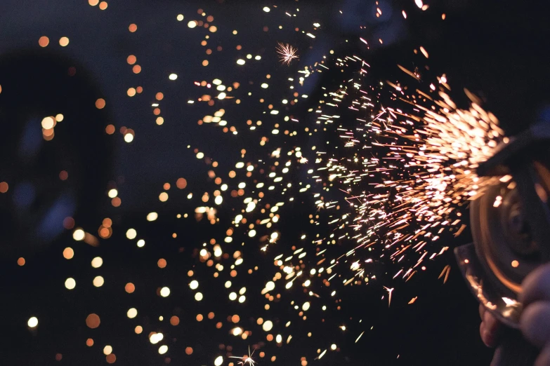 a person is holding a pipe and a fireworks