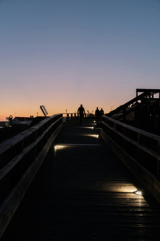 a wooden pier with a bench at the end